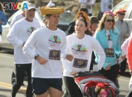 A runner with a hat shaped into a piece of pumpkin pie takes part in the 40th annual Turkey Trot to raise money for the Denver chapter of the United Way in south Denver on Thursday, Nov. 28, 2013.