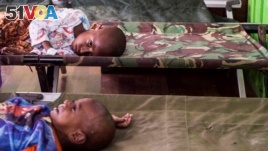 FILE - Two sick children wait for treatment after being admited to a hospital in Agats, Asmat District, after the government dispatched military and medical personnel to the remote region of Papua to combat malnutrition and measles, Indonesia, Jan. 22, 2018. (Antara Foto/M Agung Rajasa/ via REUTERS)
