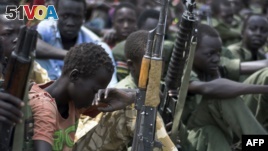 FILE - Boys with their rifles sit at a ceremony of the child soldiers disarmament, demobilization and reintegration in Pibor, Jonglei State, South Sudan.