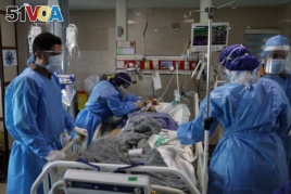 Nurses wearing protective suits, prepare a patient with coronavirus disease (COVID-19) to be transferred to Masih Daneshvari Hospital, in Tehran, Iran March 30, 2020. WANA (West Asia News Agency)/Ali Khara via REUTERS<I>&#</I>1705;<I>&#</I>1585;<I>&#</I>1608;<I>&#</I>1606;<I>&#</I>1575; <I>&#</I>1575;<I>&#</I>1740;<I>&#</I>1585;<I>&#</I>1575;<I>&#</I>1606;