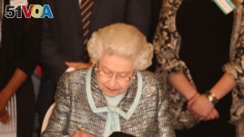 Queen Elizabeth II, Head of the Commonwealth signs the Commonwealth Charter at a reception at Marlborough House, London.