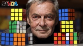 FILE - Erno Rubik, the inventor of the Rubik's Cube, poses with cubes at Liberty Science Center, Wednesday, April 25, 2012, in Jersey City, N.J. An extremely small Rubik's Cube has gone on sale in Japan for 198,000 yen, or about $1,900. (AP Photo/Julio Cortez)