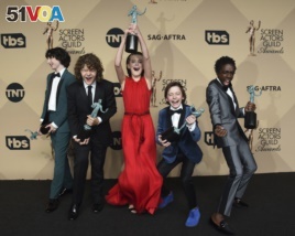 Finn Wolfhard, from left, Gaten Matarazzo, Millie Bobby Brown, Noah Schnapp, and Caleb McLaughlin pose in the press room with the awards for outstanding performance by an ensemble in a drama series for 
