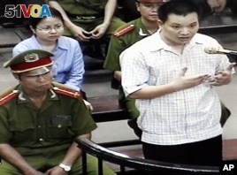Nguyen Van Dai, right, testifies in this May 2013 file photo, originally taken from TV footage. The well-known Vietnamese human rights lawyer was arrested on anti-state 