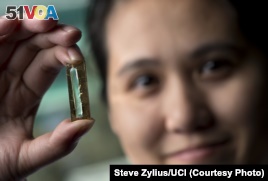 UCI chemist Reginald Penner and doctoral student Mya Le Thai, shown, have developed a nanowire-based battery technology that allows lithium ion batteries to be recharged hundreds of thousands of times.   Steve Zylius/UCI