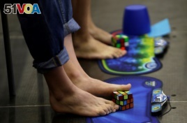 Competitors solve Rubik's cubes using their feet during the Rubik's Cube European Championship in Prague, July 2016.