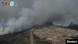 A Canadian Joint Operations Command aerial photo shows wildfires near neighborhoods in Fort McMurray, Alberta. (CF Operations)