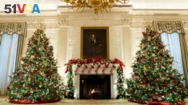 The State Dining Room of the White House is decorated for the holiday season during a press preview of the White House holiday decorations, on Monday, Nov. 29, 2021, in Washington. (AP Photo/Evan Vucci)