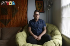 In this photo taken Thursday, May 5, 2016 Joaquin Carca<I>&#</I>241;o is shown at his home in Carrboro, N.C. Carca<I>&#</I>241;o, a 27-year-old transgender man, works for the University of North Carolina at Chapel Hill.