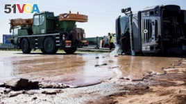 Tons of liquid milk chocolate are spilled and block six lanes on a highway after a truck transporting it overturned near Slupca, in western Poland, on Wednesday, May 9, 2018. (AP Photo)
