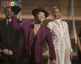 FILE - Bruno Mars accepts the award for record of the year for 