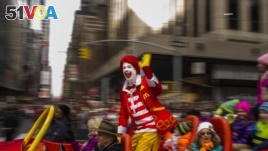 FILE - Ronald McDonald waves to the crowd during the Macy's Thanksgiving Day Parade, in New York, on November 26, 2015. McDonald's says Ronald McDonald is keeping a low profile with reports of creepy clown sightings on the rise.