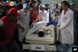 Medical staff move landslide survivor Tian Zeming following surgery in a hospital in Shenzhen in southern China's Guangdong province on Dec. 23, 2015. Rescuers pulled Tian from the rubble of a massive landslide in Shenzhen early on Wednesday. (Chinatopix via AP) 