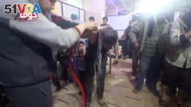 A man is hosed off following an alleged chemical weapons attack in what is said to be Douma, Syria, in this still image from video obtained by Reuters, April 8, 2018. (White Helmets/Reuters TV)