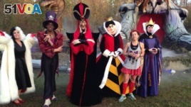 Kathy Pride poses with Disney characters after the Walt Disney World Marathon.