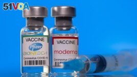 Vials with Pfizer-BioNTech and Moderna coronavirus disease (COVID-19) vaccine labels are seen in this illustration picture taken March 19, 2021. REUTERS/Dado Ruvic/Illustration/File