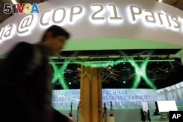 A man walks past the Indian Pavilion at the COP21, the United Nations Climate Change Conference Monday, Dec. 7, 2015 in Le Bourget, north of Paris. (AP Photo/Christophe Ena)