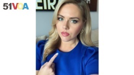 In this July 23, 2020 selfie provided by Victoria Price, Price, a reporter for WFLA in Tampa, Fla., points to her neck. The television news reporter is crediting an eagle-eyed viewer for noticing a lump on her neck and emailing her that she should get it 