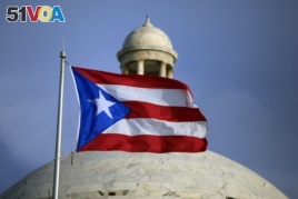The Puerto Rican flag flies in front of Puerto Rico's Capitol in San Juan