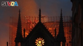 FILE - Flames and smoke rise from Notre Dame cathedral as it burns in Paris, Monday, April 15, 2019. (AP Photo/Thibault Camus)