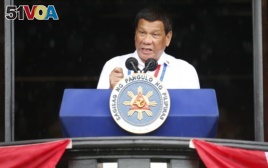 Philippine President Rodrigo Duterte gestures while addressing the crowd after leading the flag-raising rites at the 120th Philippine Independence Day celebration at the Emilio Aguinaldo Shrine at Kawit, Cavite province south of Manila, June 12, 2018.
