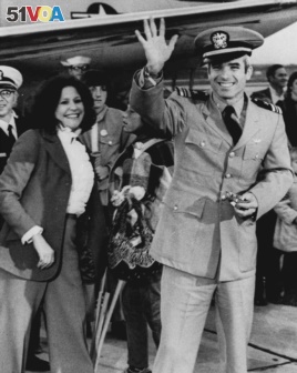Lt. Commander John S. McCain III, a POW for over five years, waves to well wishers March 18, 1973 after arriving at Jacksonville Naval Air Station in Florida. (AP Photo)