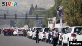A convoy consisting of Red Cross, Red Crescent and United Nation (UN) gather before heading towards to Madaya from Damascus, and to al Foua and Kefraya in Idlib province, Syria, Jan. 11, 2016. 