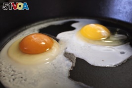 These are eggs frying in a pan.