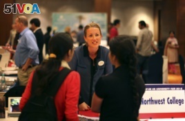 Indian students listen to a representative of Northwest College during a U.S. University fair organized by EducationUSA in New Delhi, India, Saturday, November. 3, 2012.