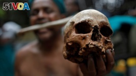 A farmer from Tamil Nadu state shows a skull, who he says are the remains of a Tamil farmer who took his own life. The living farmer is at a protest demanding good rates for their crops among other things in New Delhi, India on July 17, 2017.