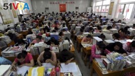 In this June 2, 2012 photo, students prepare for the university entrance exam in a classroom in Hefei, Anhui Province. If you read the room here, what would the mood be? (REUTERS/Stringer)