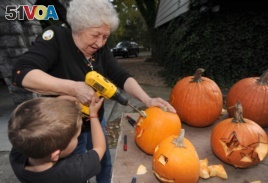 For Halloween, Betty Dillow of Bristol, Virgina helps her grandson carve his pumpkin with a power drill, 2013.
