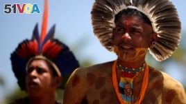 FILE - Indigenous people from ethnic groups Pataxo and Tupinamba attend a protest to defend indigenous land, outside Brazil's Supreme Federal Court in Brasilia, Brazil, Oct. 16, 2019. 