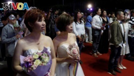 Gay and lesbian newlyweds attend a mass wedding banquet, one day after same-sex marriage officially became legal May 25, 2019. REUTERS/Tyrone Siu