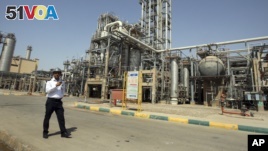 FILE - In this 2011 file photo, an Iranian security guard stands at the Maroun Petrochemical plant at the Imam Khomeini port, southwestern Iran. U.S. companies are interested in developing markets in Iran.