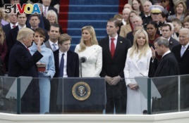Donald Trump is sworn in as the 45th president of the United States by Chief Justice John Roberts as Melania Trump and his family looks on during the 58th Presidential Inauguration at the U.S. Capitol in Washington, Jan. 20, 2017.