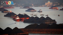 FILE - Coal barges are pictured as they queue to be pull along Mahakam river in Samarinda, East Kalimantan province, Indonesia, August 31, 2019. (REUTERS/Willy Kurniawan)