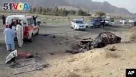 This photo taken by freelance photographer Abdul Malik on Saturday, May 21, 2016, purports to show volunteers standing near the wreckage of the destroyed vehicle, in which Mullah Mohammad Akhtar Mansour was allegedly traveling in the Ahmed Wal area in Baluchistan province of Pakistan, near Afghanistan border. A senior commander of the Afghan Taliban confirmed on Sunday that the extremist group's leader, Mullah Mohammad Akhtar Mansour, has been killed in a U.S. drone strike. (AP Photo/Abdul Malik)