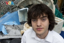Dutch inventor Boyan Slat stands next to a pile of plastic garbage prior to a 2017 press conference in Utrecht, Netherlands.