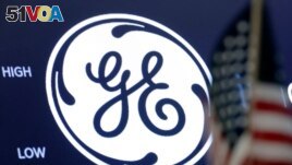 FILE - The General Electric logo appears above a trading post on the floor of the New York Stock Exchange, June 26, 2018. 