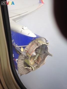 FILE - This Saturday, Aug. 27, 2016 photo shows an engine through a window of a Southwest Airlines flight. The flight from New Orleans bound for Orlando, Fla., diverted to Pensacola, Fla., after the pilot detected something had gone wrong with an engine