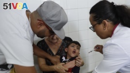A boy cries as he receives a vaccine against yellow fever at a public health center in Sao Paulo, Brazil, Jan. 16, 2018.