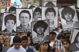 Demonstrators shouts slogans against pardon of former President Alberto Fujimori with photographs of people disappeared during his government, in Lima, Peru, Monday, Dec. 25, 2017.