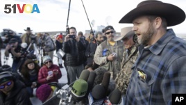 Ammon Bundy, a leader of the occupying protesters at the Malheur National Wildlife Refuge, speaks to reporters during a news conference at the refuge near Burns, Ore., Jan. 6, 2016. (AP Photo/Rick Bowmer)