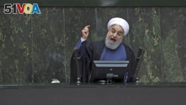 Iranian President Hassan Rouhani speaks in a session of the parliament in Tehran on August 28, 2018. Experts say Iran has a network of media providers aimed at spreading Iranian influence around the world. (AP Photo/Vahid Salemi)