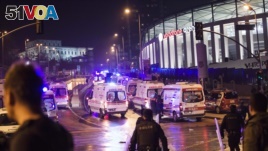 Police officers and ambulances fill the street next to the Besiktas football club stadium, in Istanbul, late Saturday, Dec. 10, 2016. 