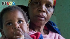 A child with HIV is given medication by a care-giver in Durban, South Africa.