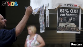 A man looks at newspapers showing the results of yesterday's referendum in central Athens, Greece, July 6, 2015. Greeks overwhelmingly rejected conditions of a rescue package from creditors on Sunday, throwing the future of the country's euro zone members. (REUTERS/Christian Hartmann)