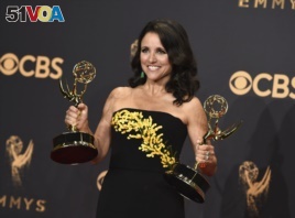 FILE - Julia Louis-Dreyfus poses in the press room with her awards for outstanding lead actress in a comedy series and outstanding comedy series for 