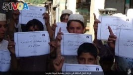 IS social media distributed photos in several languages of children holding placards in Islamic State territories offering 